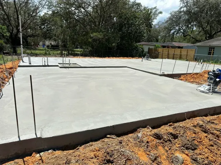 Fresh concrete slab foundation with formed edges on a cleared building lot, Brooksville, FL